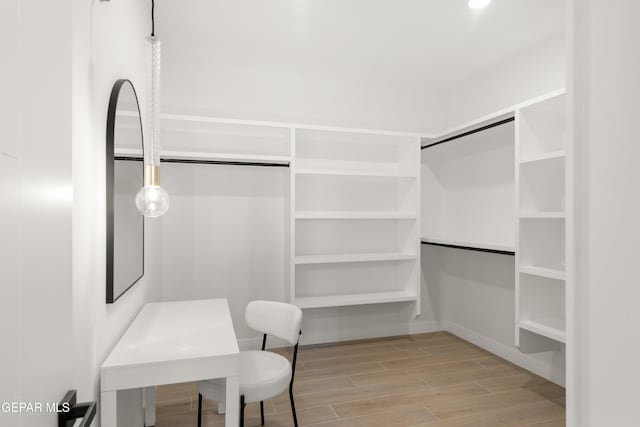 spacious closet featuring wood finish floors