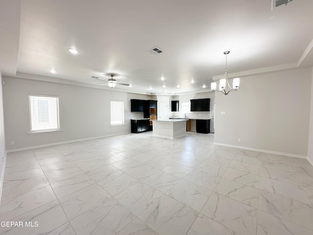 unfurnished living room with visible vents, marble finish floor, ceiling fan with notable chandelier, recessed lighting, and baseboards