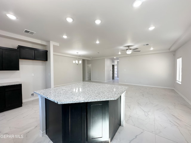 kitchen with recessed lighting, visible vents, marble finish floor, and dark cabinets