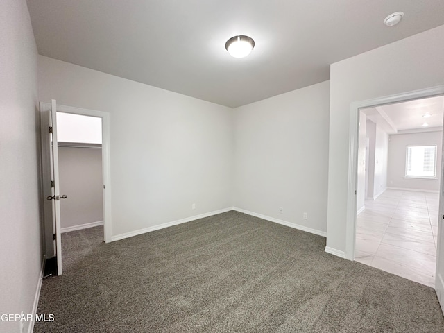 carpeted spare room with baseboards