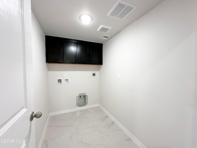 laundry area with electric dryer hookup, visible vents, marble finish floor, cabinet space, and baseboards