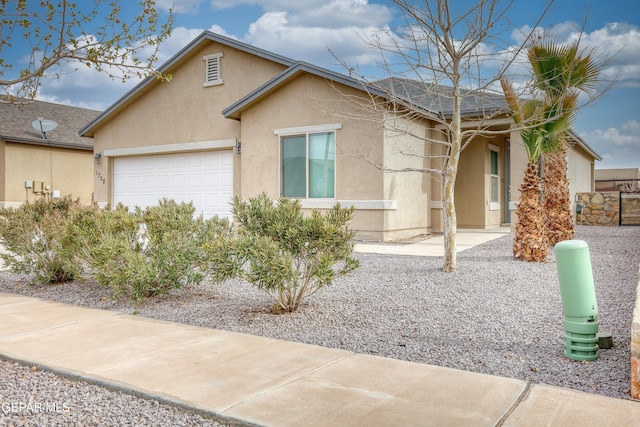 ranch-style house featuring stucco siding and an attached garage