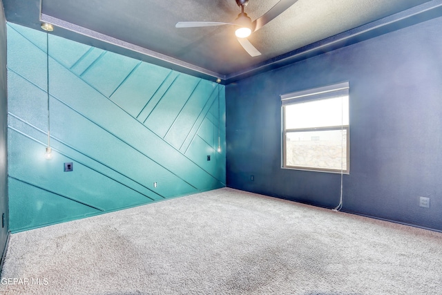 carpeted spare room with ceiling fan