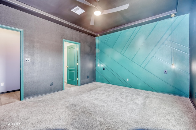 unfurnished bedroom featuring visible vents, connected bathroom, a ceiling fan, and carpet floors