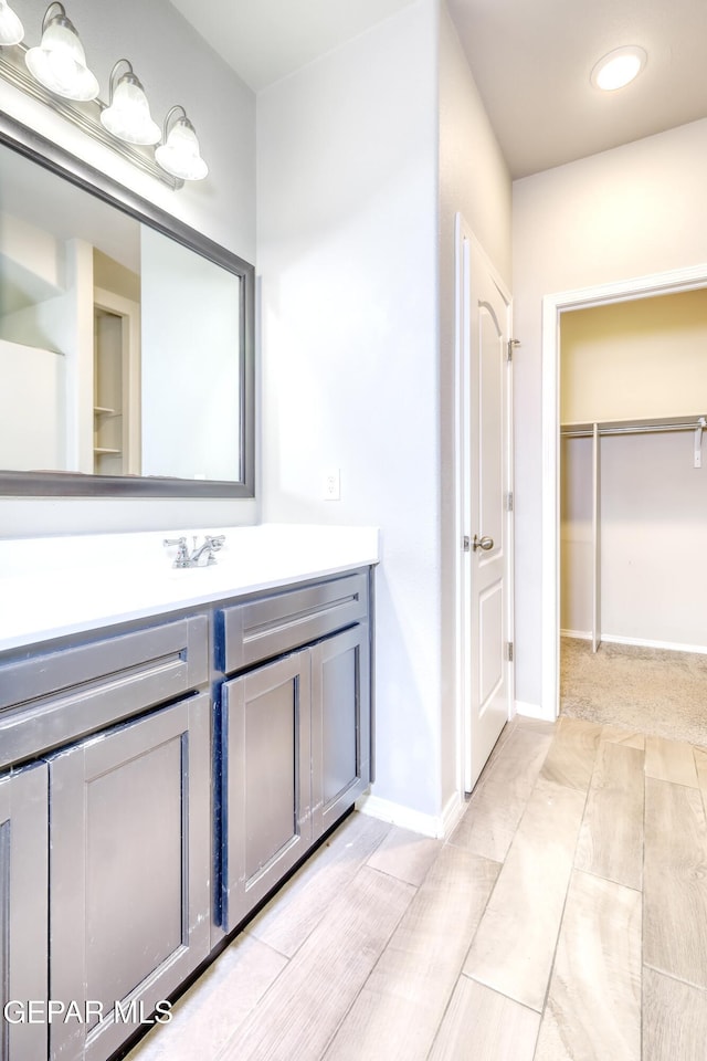 bathroom with baseboards and vanity