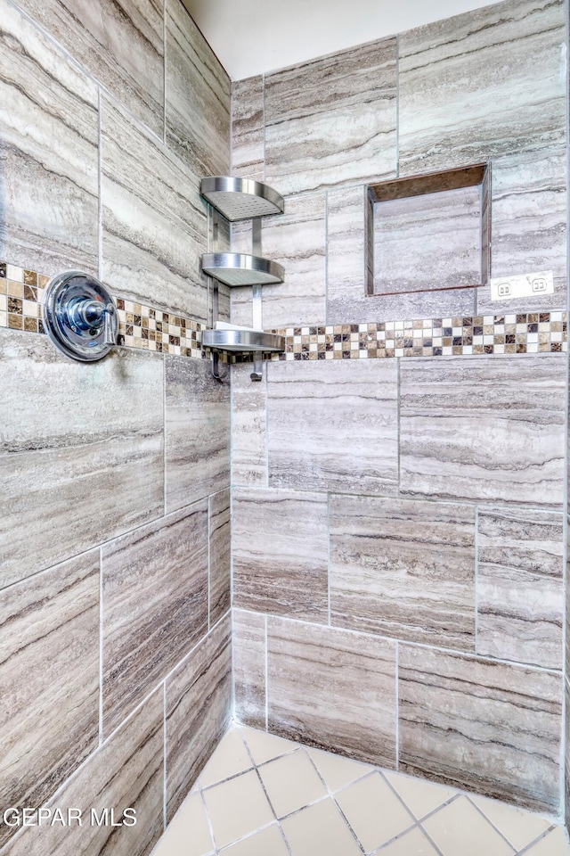 bathroom with tiled shower