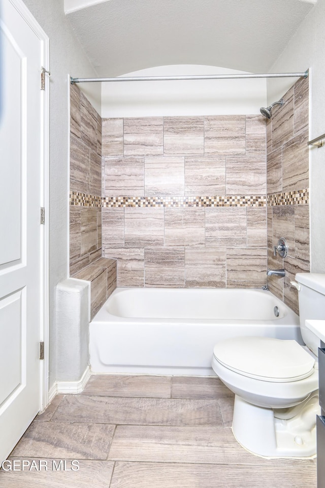 bathroom with shower / washtub combination and toilet