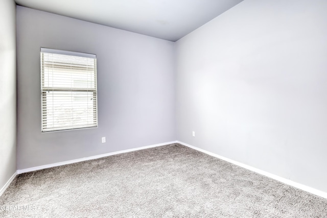 empty room featuring baseboards and carpet floors