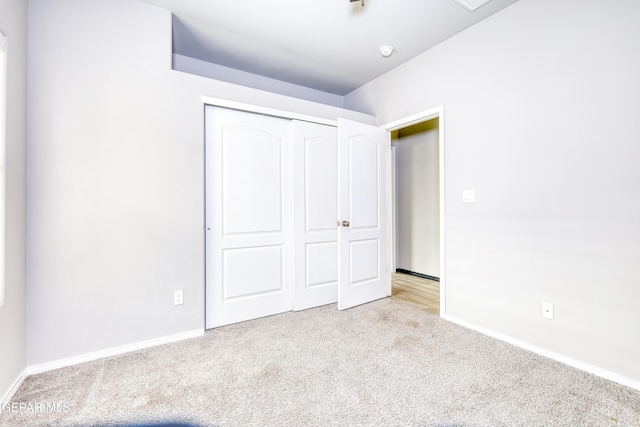 unfurnished bedroom with baseboards, a closet, and carpet floors