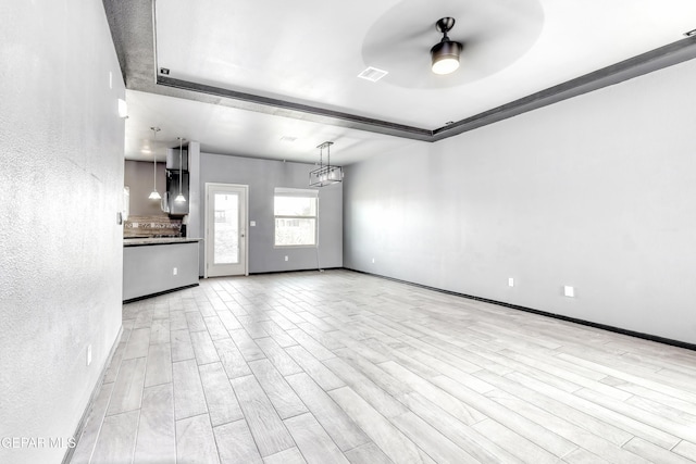 1722 Breeder Cup Way, El Paso, TX 79928 - unfurnished living room featuring ceiling fan, wood finished floors, a raised ceiling, and a textured wall