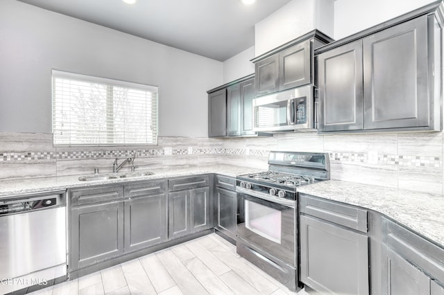 1722 Breeder Cup Way, El Paso, TX 79928 - kitchen featuring stainless steel appliances, a sink, backsplash, light stone countertops, and recessed lighting