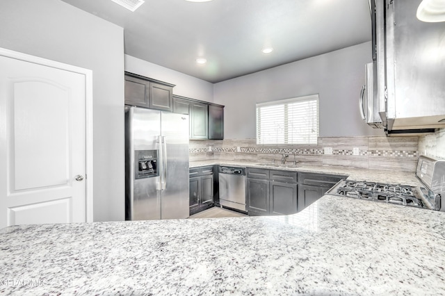 1722 Breeder Cup Way, El Paso, TX 79928 - kitchen with stainless steel appliances, a sink, light stone counters, backsplash, and recessed lighting