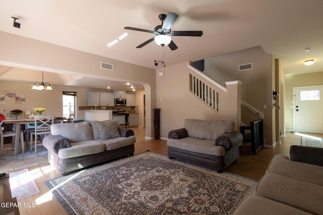 living area featuring visible vents, plenty of natural light, and stairs