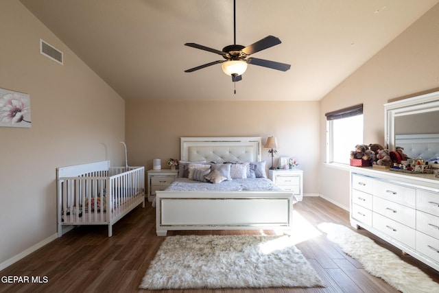 bedroom with visible vents, baseboards, wood finished floors, and vaulted ceiling