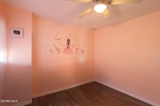 unfurnished room with ceiling fan, baseboards, and dark wood-style flooring