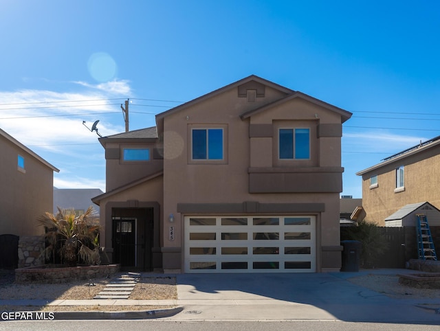 view of front of house with concrete driveway, a garage, and stucco siding