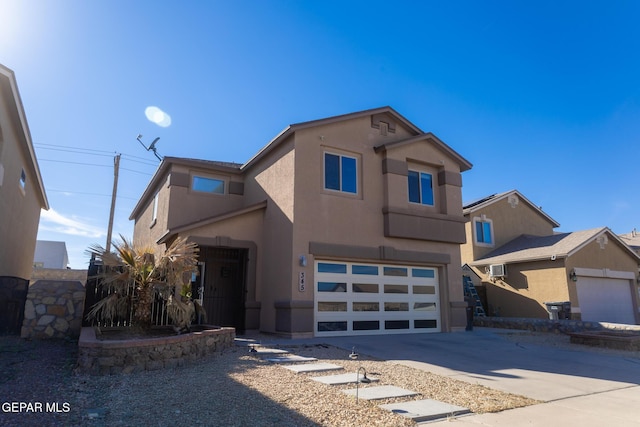 view of front facade featuring an attached garage, driveway, and stucco siding