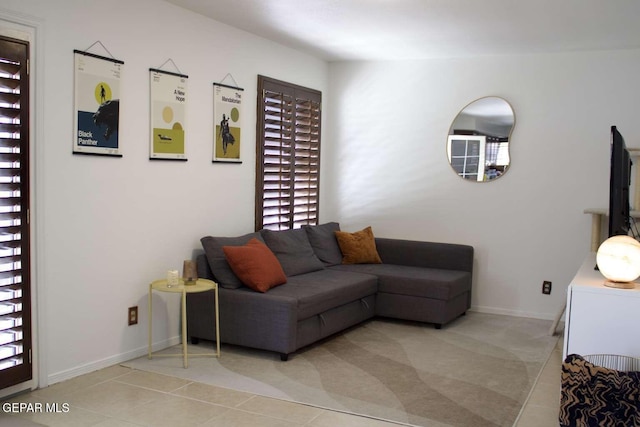 living area featuring tile patterned flooring and baseboards