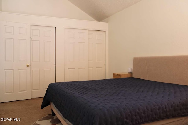 carpeted bedroom featuring lofted ceiling