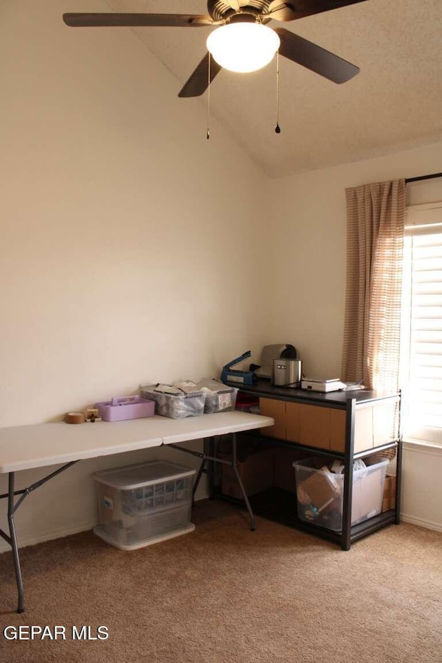 office featuring light carpet, a healthy amount of sunlight, a ceiling fan, and vaulted ceiling