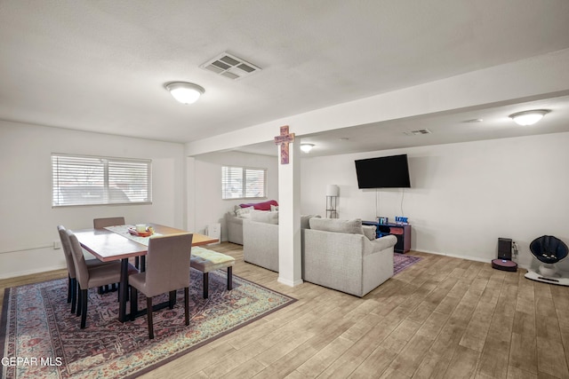 dining room featuring visible vents and light wood-style floors