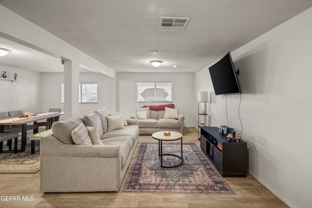 living area featuring visible vents and baseboards