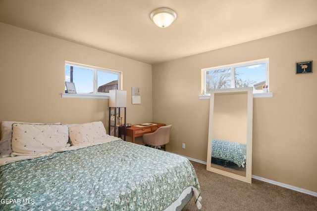 carpeted bedroom featuring baseboards