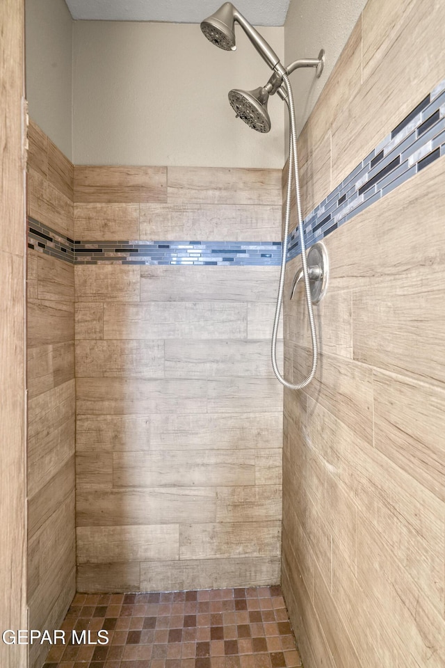 bathroom with tiled shower