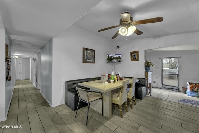 dining area featuring ceiling fan and wood tiled floor