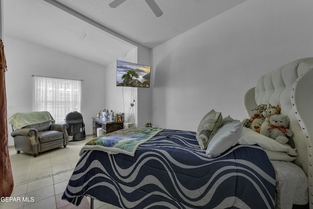 bedroom with tile patterned floors, ceiling fan, a textured ceiling, and lofted ceiling