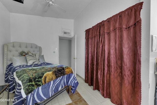 bedroom with visible vents, light tile patterned flooring, and a ceiling fan