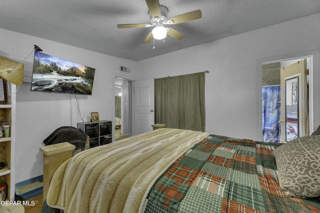 bedroom featuring ceiling fan, visible vents, and a textured ceiling