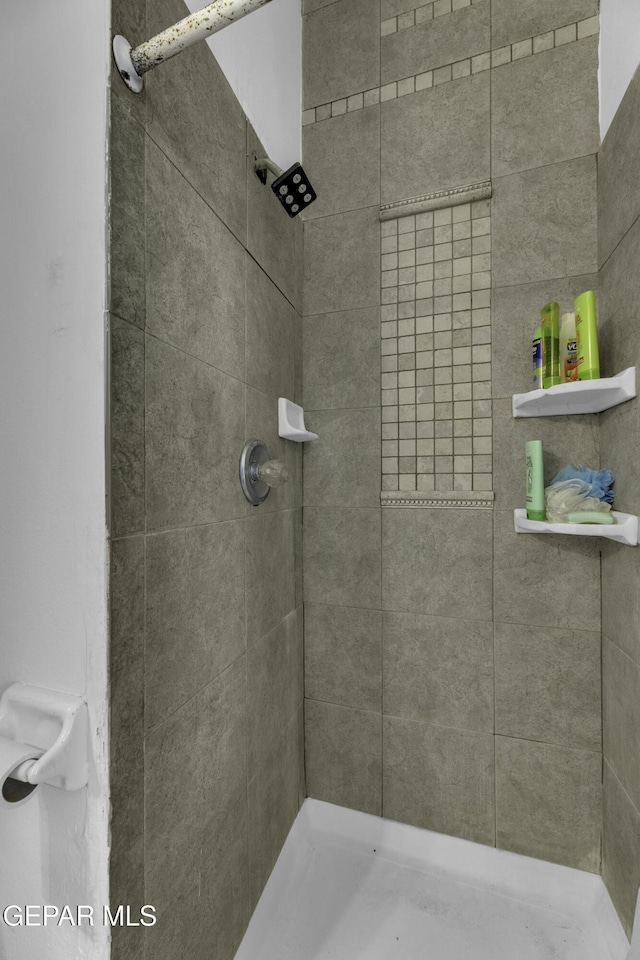 bathroom with tiled shower