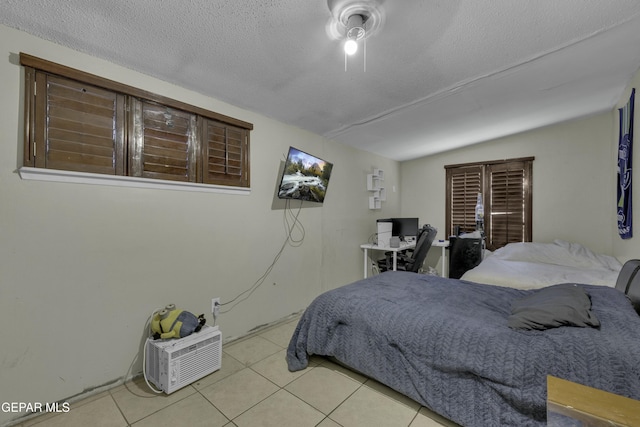 tiled bedroom featuring a textured ceiling