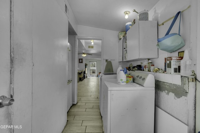 laundry area with visible vents, cabinet space, washer and dryer, and a ceiling fan