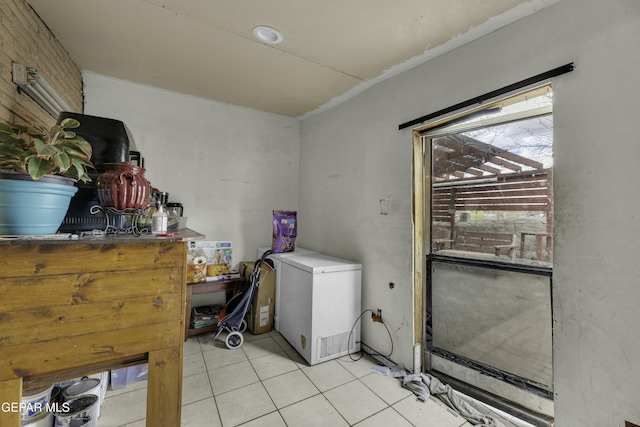 laundry area with light tile patterned floors