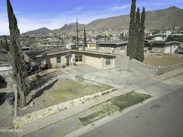 view of front of property featuring brick siding and a mountain view