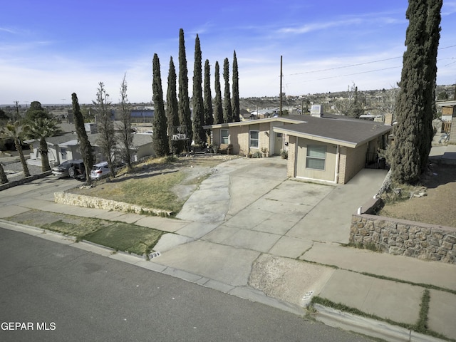 view of front of house featuring brick siding and driveway