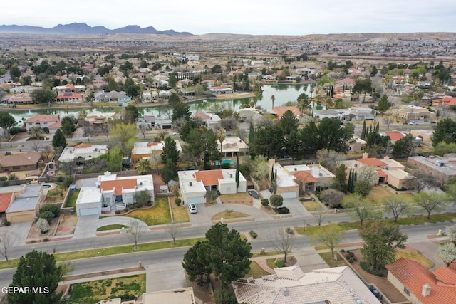 birds eye view of property with a residential view and a water and mountain view