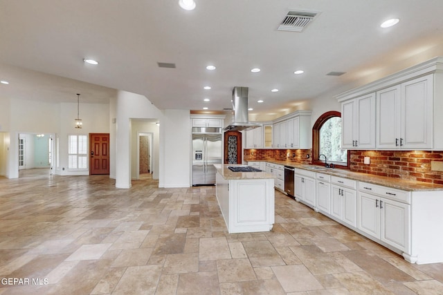 kitchen with visible vents, a sink, a center island, appliances with stainless steel finishes, and island range hood