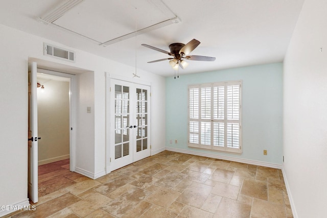 empty room featuring visible vents, baseboards, attic access, and french doors