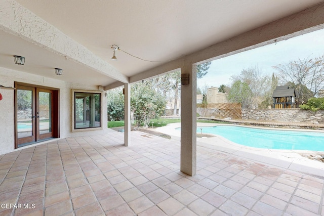 outdoor pool featuring a patio area and french doors