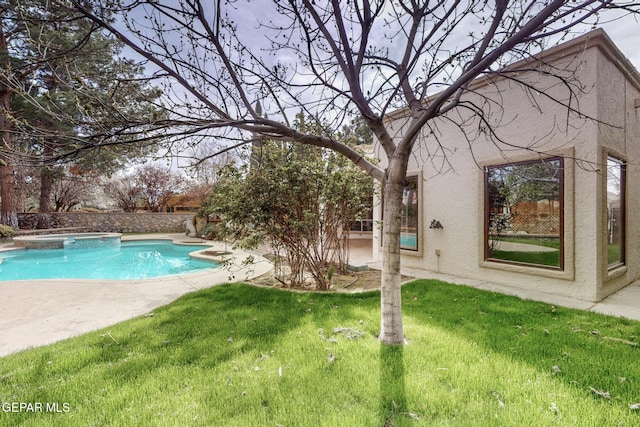 view of swimming pool featuring a yard, a patio area, and a pool with connected hot tub