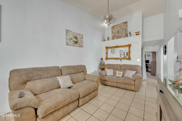 living area with light tile patterned flooring and a towering ceiling