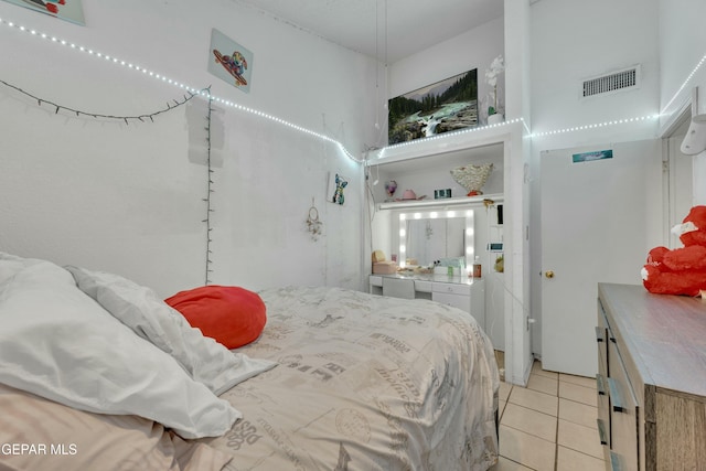 bedroom with light tile patterned floors and visible vents