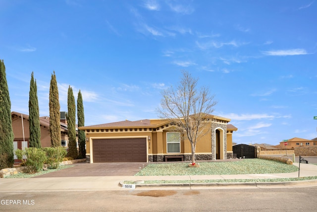 view of front of home with stone siding, stucco siding, driveway, and an attached garage