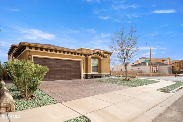 view of front of property with stone siding, stucco siding, decorative driveway, and a garage