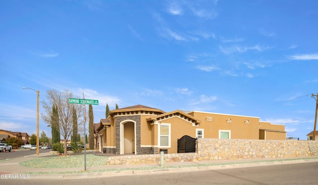 view of front facade with a fenced front yard and stucco siding