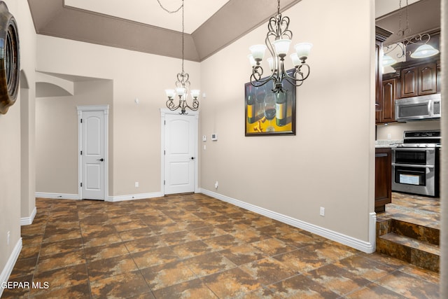 dining room with baseboards, a notable chandelier, a towering ceiling, and stone finish floor