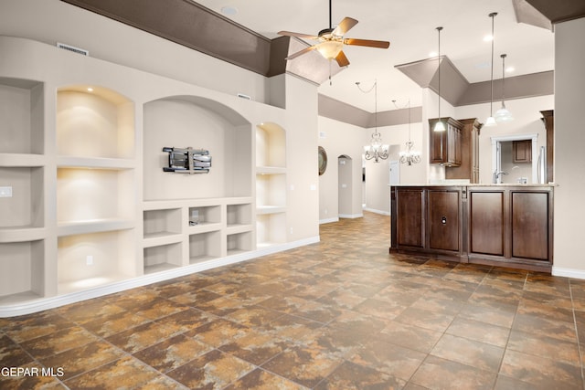 interior space featuring baseboards, dark brown cabinetry, built in features, light countertops, and a ceiling fan